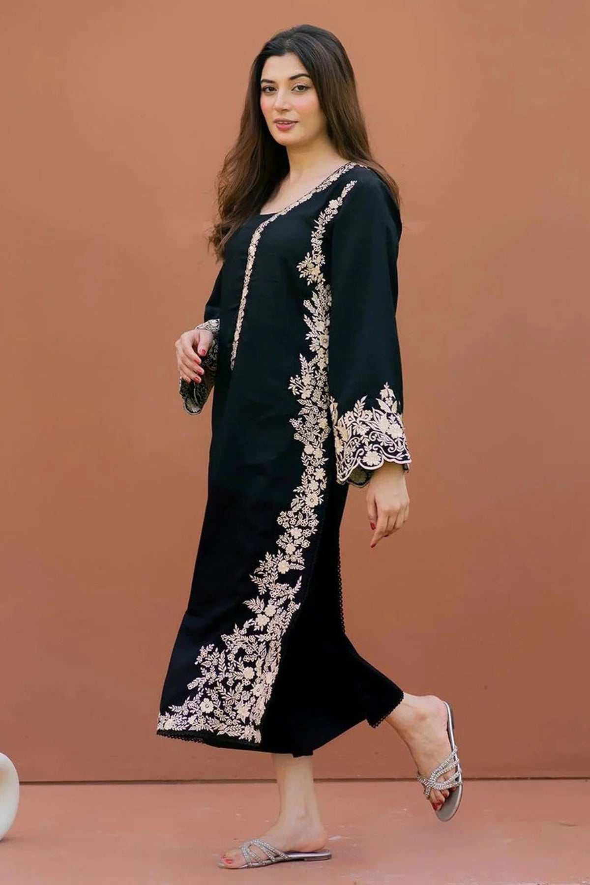 Woman wearing black lawn embroidered shirt and trouser set with floral embroidery on side and sleeves